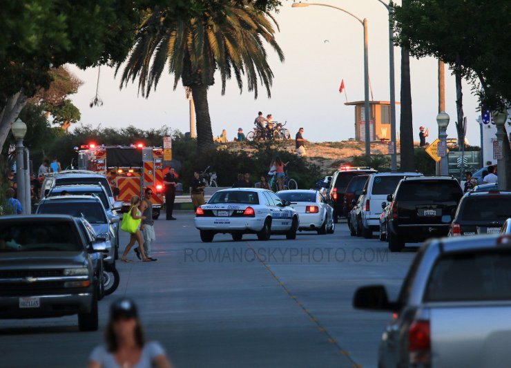 From the street at sunset 7/6/14: a somewhat familiar scene of emergency and police vehicles congregating at Wedge as the red flag on the guard stand is barely affected by a gentle breeze.