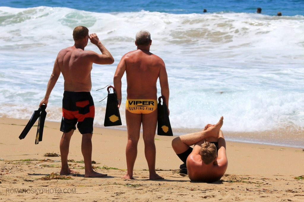 Long time bodysurfers Rick Piani and Craig Plitt standing next to a stretching Sean Starky.   These three represent 60 or more years of Wedge experience.