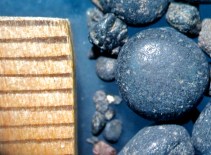 Indonesia. Black sand from volcanic rock, rounded by flowing water. 